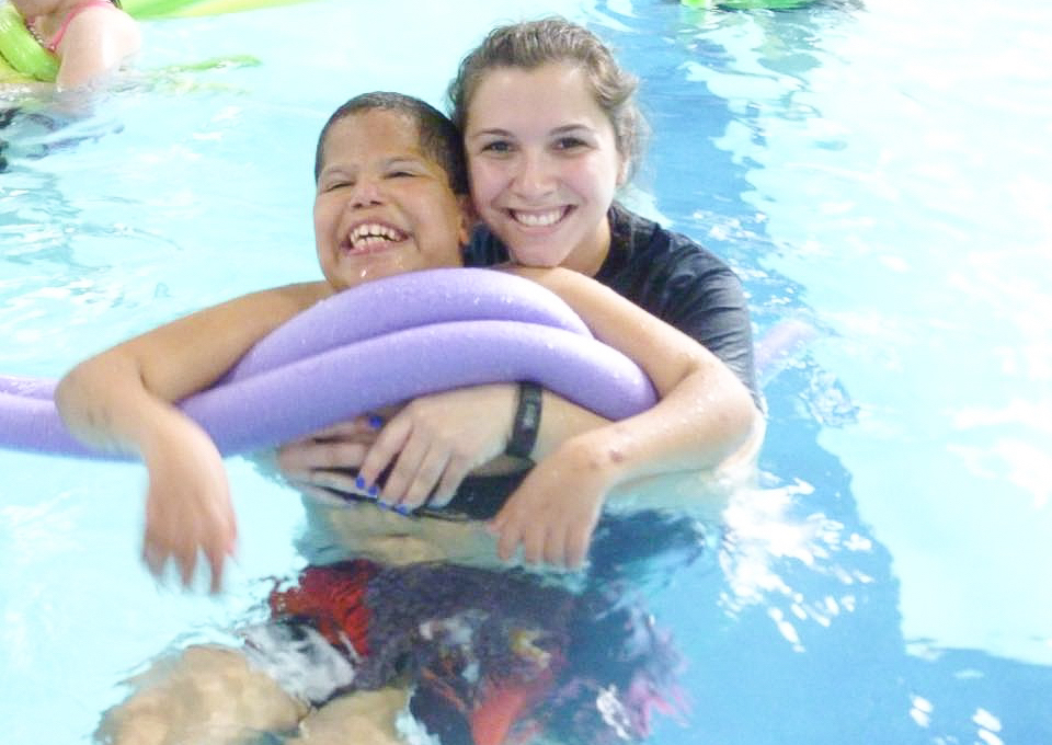Boy in pool with female staff
