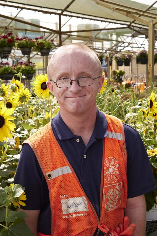 APRI Adult Services Employment middle age male smiles as he works at a garden center