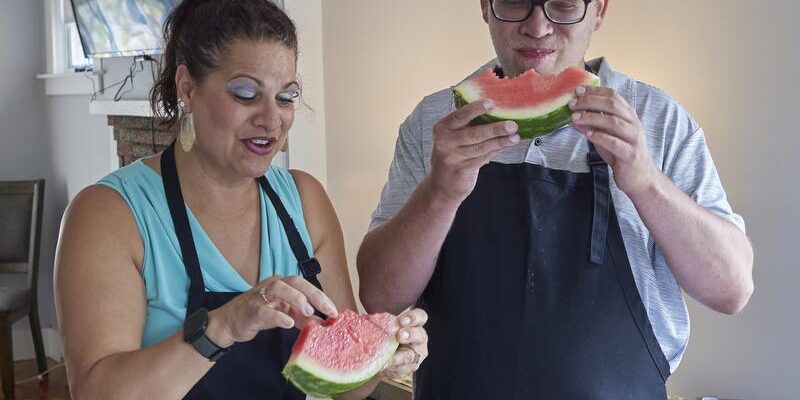 AccessPoint RI Shared Living patrons enjoying slices of watermelon in their home