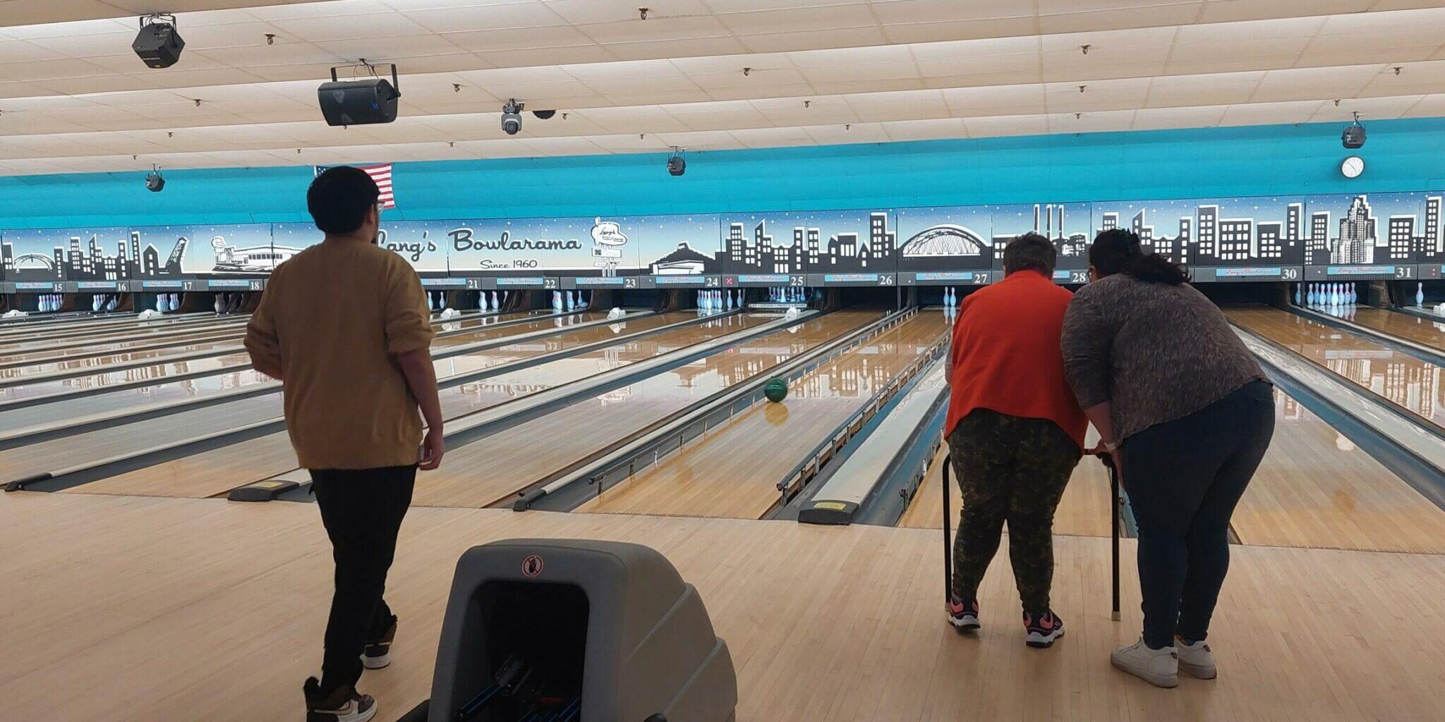 A group of participants bowling at a bowling alley