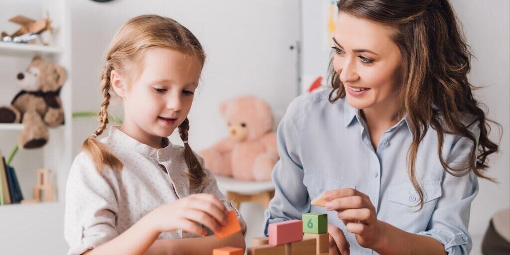 A therapist doing play therapy with a young child